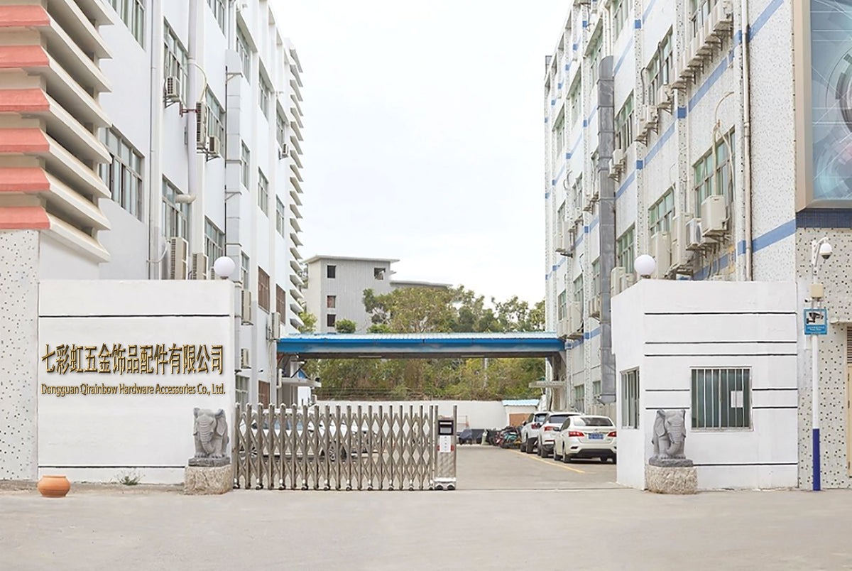 Dongguan Qirainbow Hardware Accessories Co., Ltd. factory entrance with gate and multi-story manufacturing buildings, stainless steel jewelry supplier