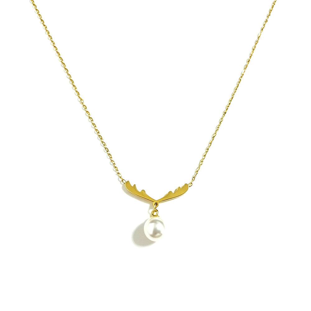 Gold antler pearl pendant necklace close-up on white background — antler charm with dangling white pearl, fine gold chain