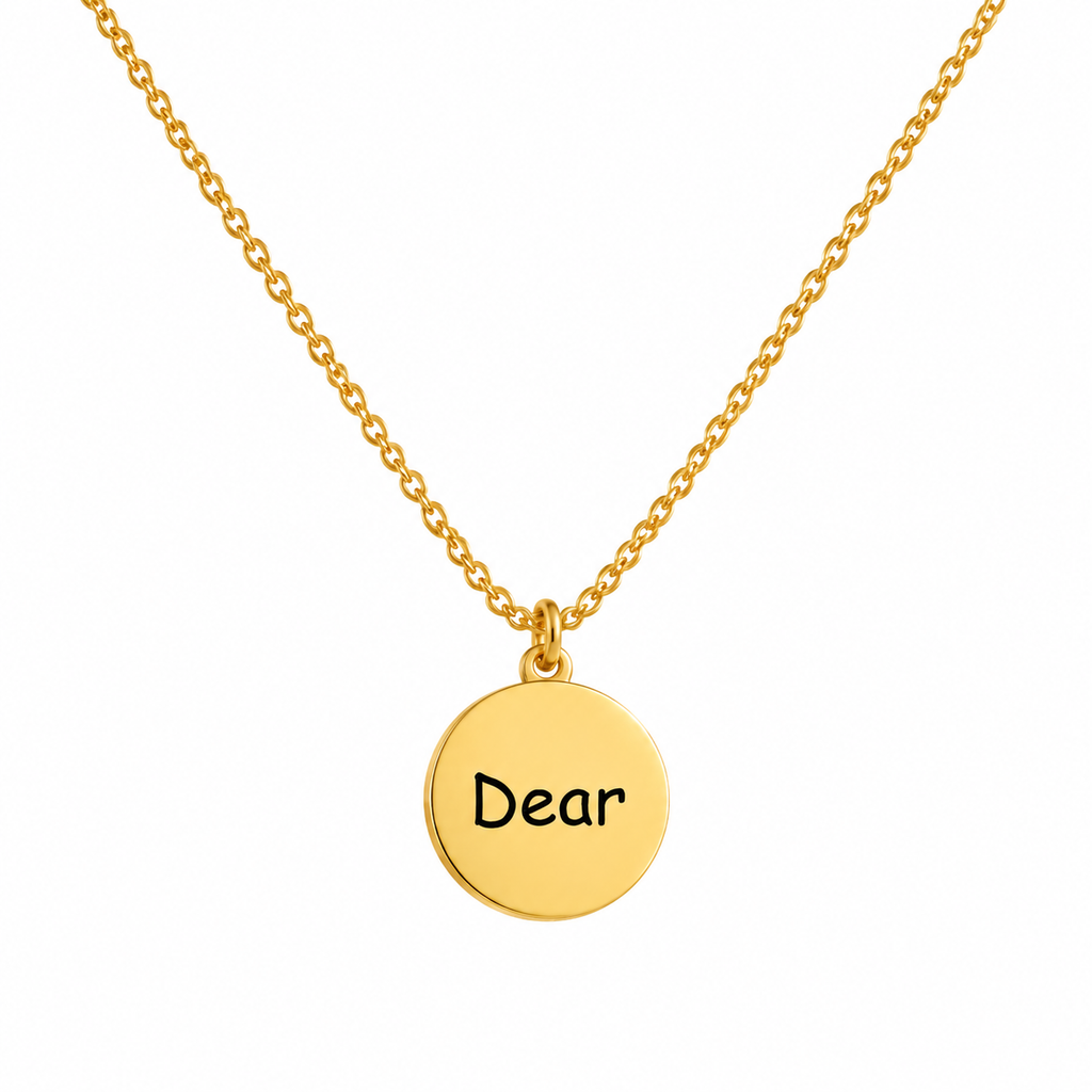 Round engraved necklace with a gold Dear coin pendant on a delicate tarnish-free stainless steel cable chain.