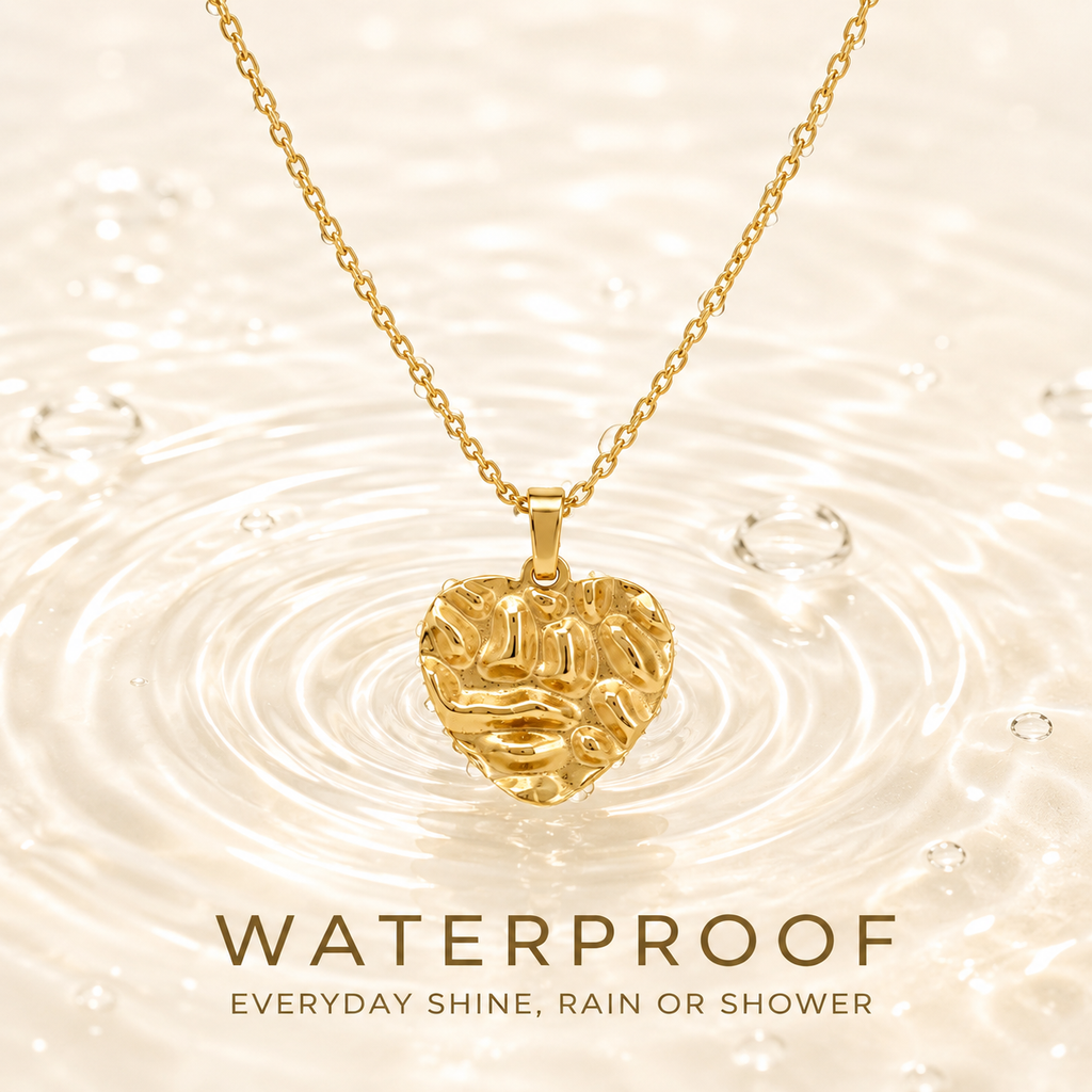 Waterproof gold PVD plated necklace with textured heart pendant dipping into water ripples, tarnish-free for daily wear.