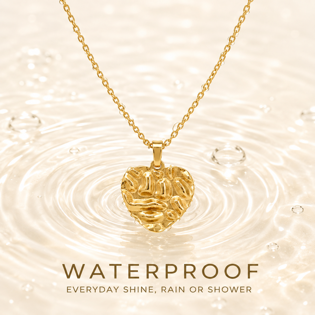 Waterproof gold PVD plated necklace with textured heart pendant dipping into water ripples, tarnish-free for daily wear.