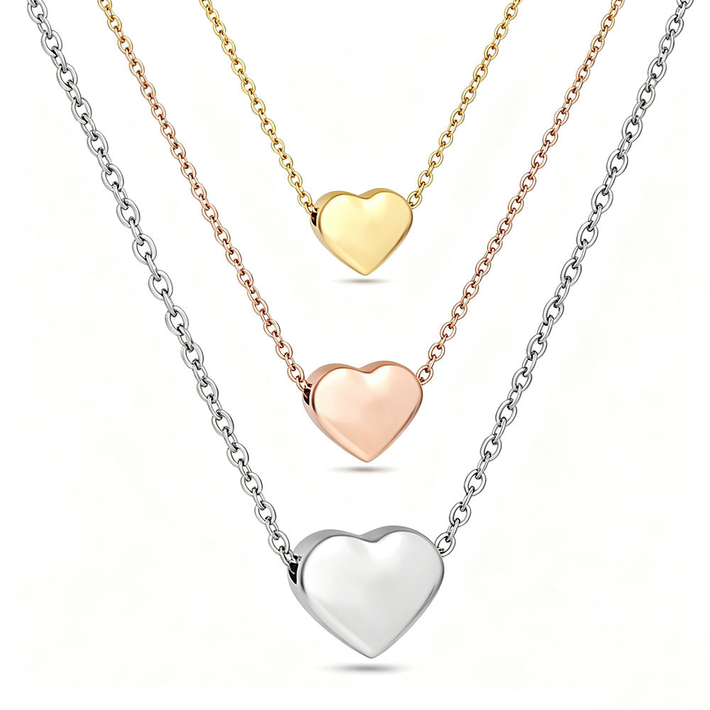 Three stainless steel heart pendant necklaces in gold, rose gold, and silver color options on white background