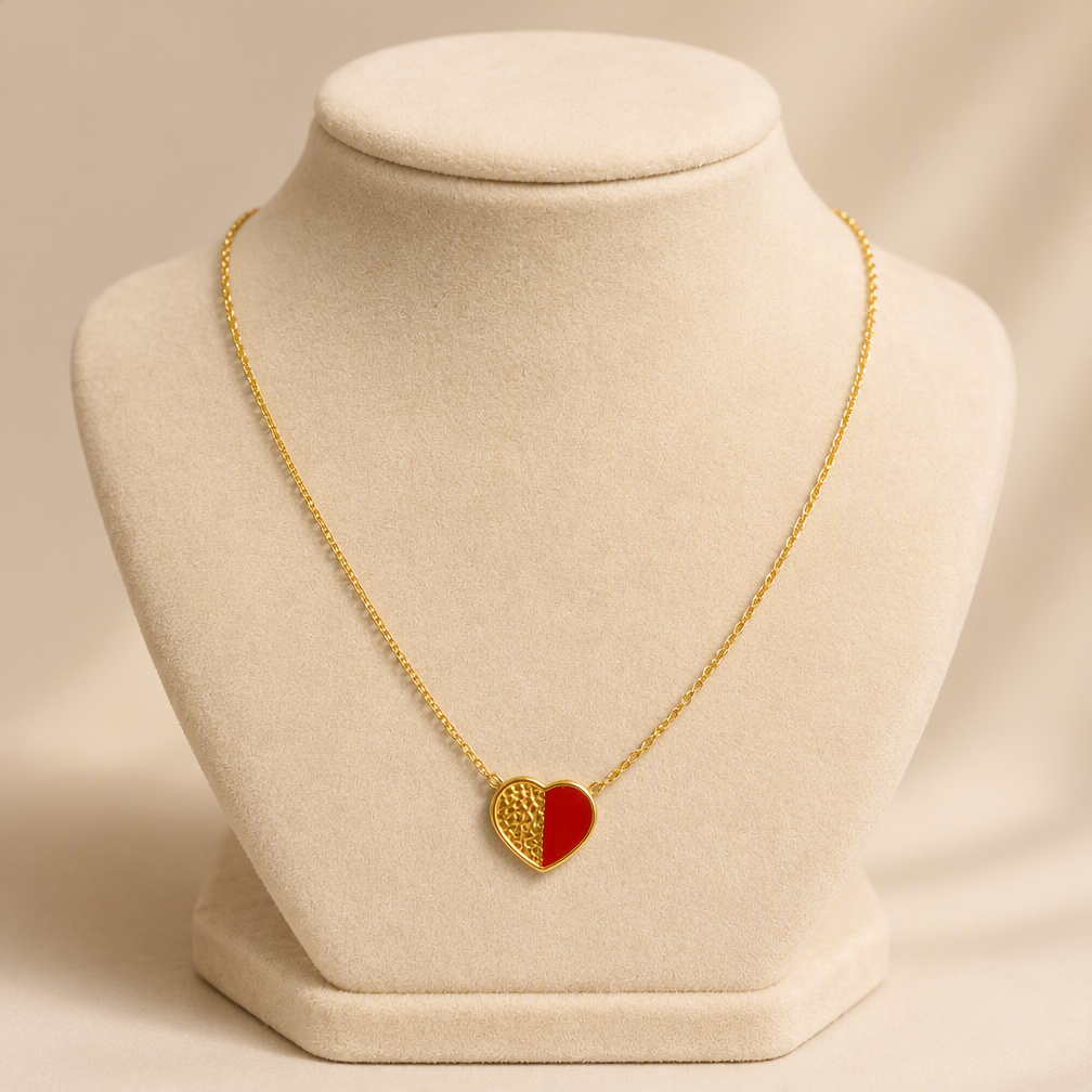 Women's 18K gold plated red enamel heart pendant necklace on jewelry display bust — stainless steel two-tone hammered gold and red heart charm on delicate cable chain