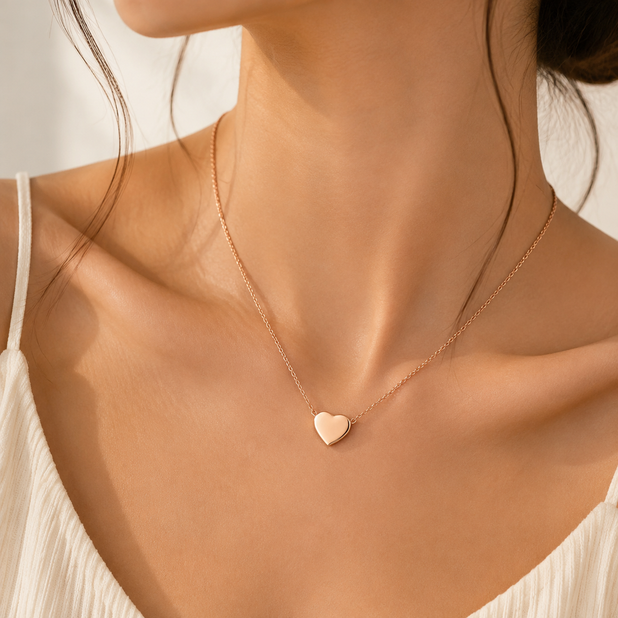 Model wearing rose gold dainty heart pendant necklace on delicate cable chain, minimalist everyday jewelry